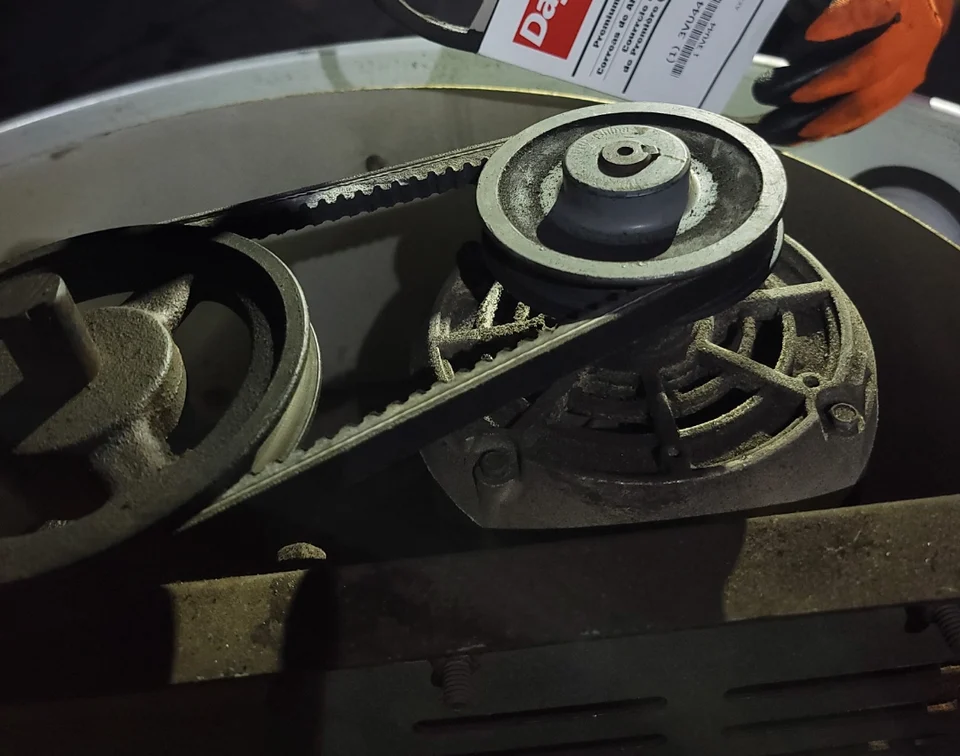 Rooftop kitchen exhaust fan belt and pulley assembly during belt replacement
