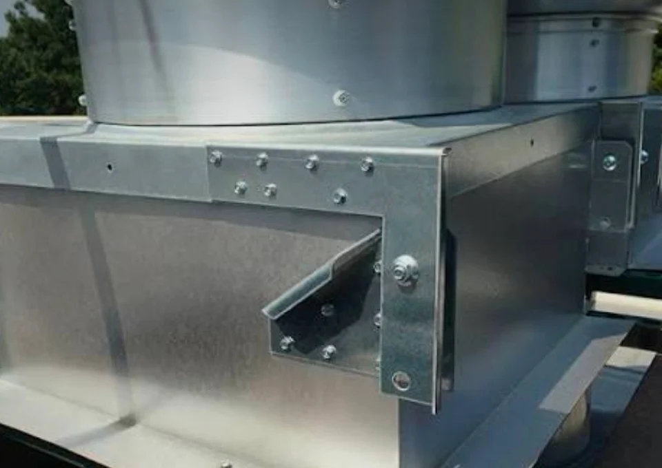 Installed rooftop exhaust fan mounting brackets and service-access hardware