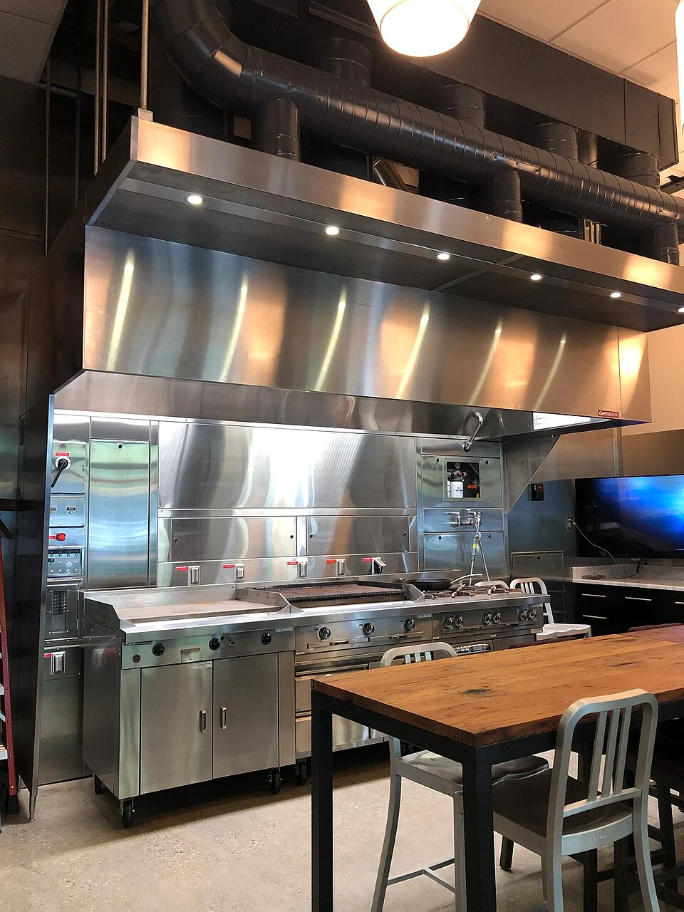 Stainless steel commercial cooking exhaust hood and its visible seams